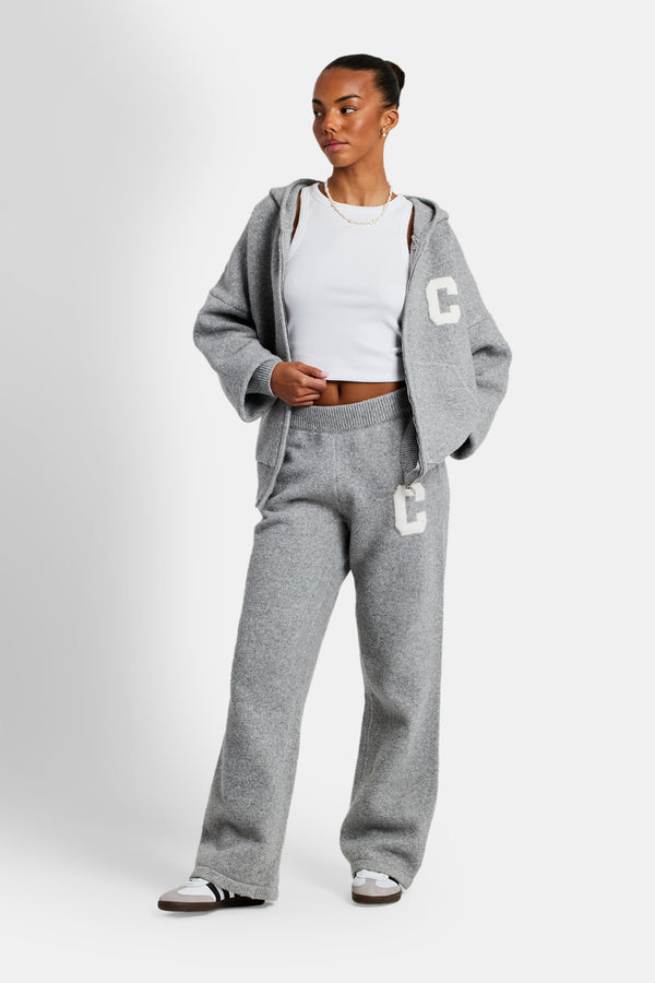 female model wearing the hodded zip through knitted tracksuit in grey