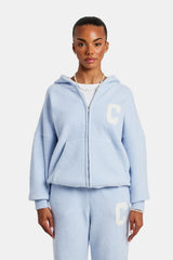 Female Model wearing hooded zip through knitted tracksuit in light blue