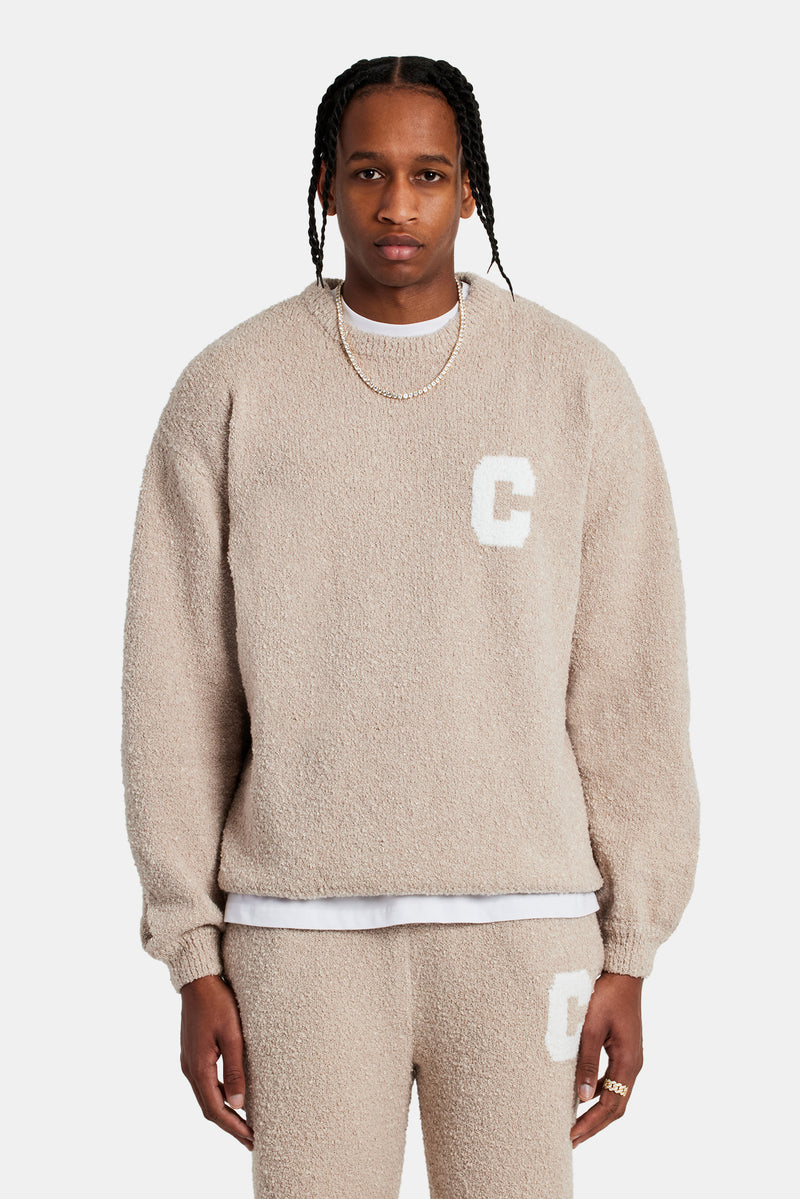 Male model wearing textured knitted sweatshirt in beige 