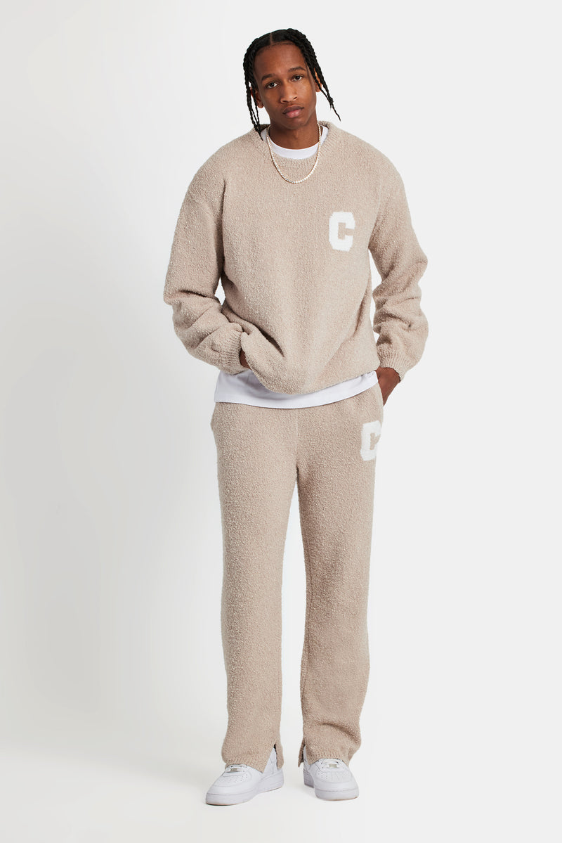 Male model wearing textured knitted sweatshirt in beige