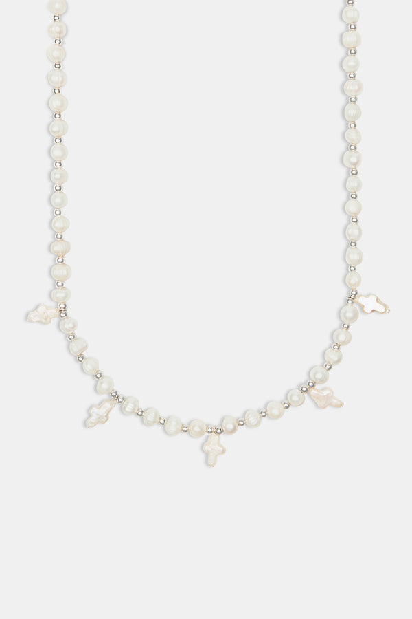 Freshwater pearl cross necklace on white background