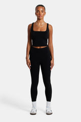 Female model wearing the deep waistband leggings in black